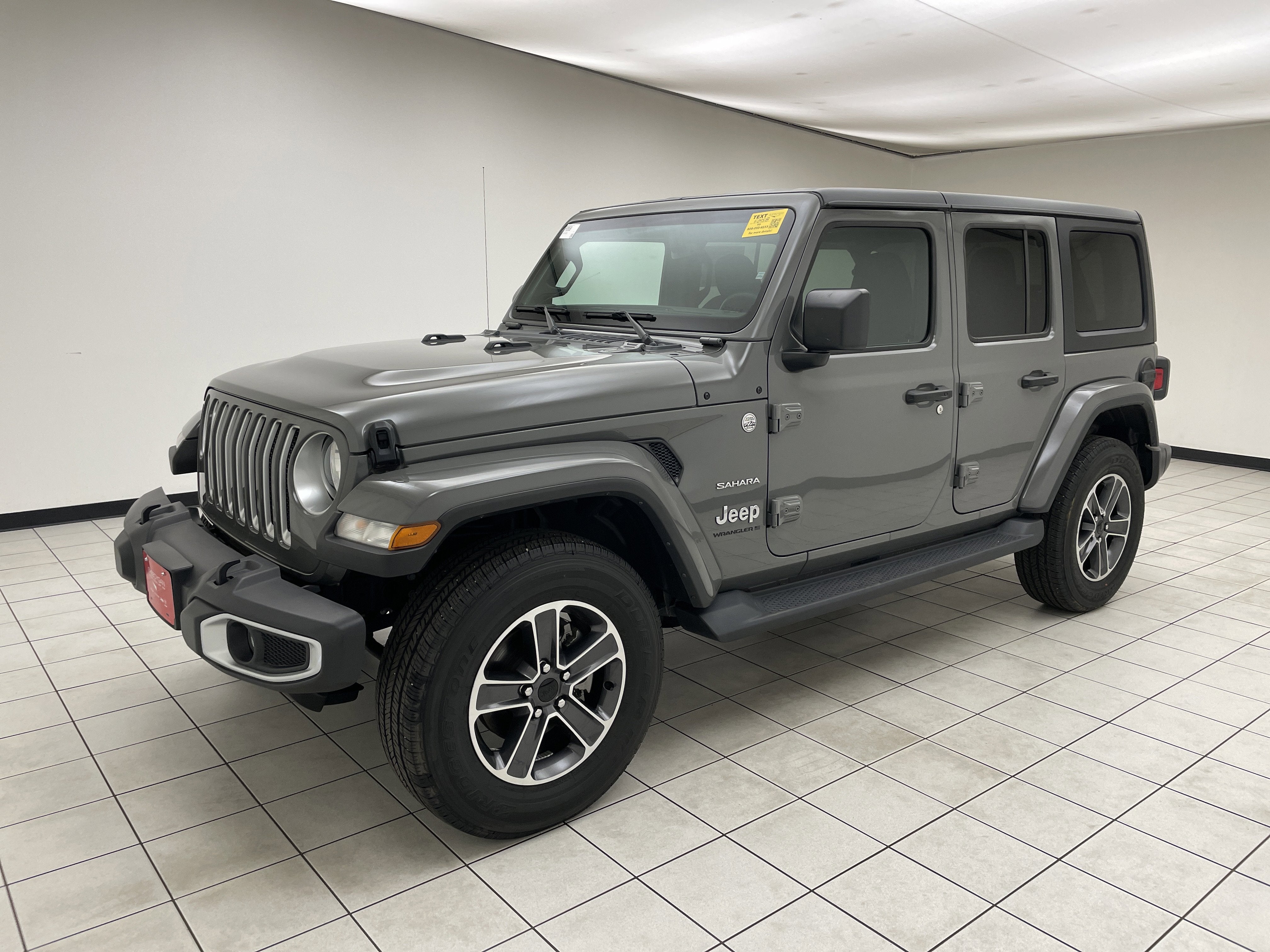 2023 Jeep Wrangler 4-Door Sahara 4x4 in Sting-Gray Clearcoat — front three-quarter view